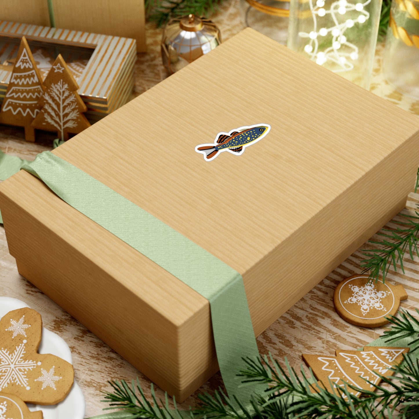 Celestial Pearl Danio sticker on a gift box with green ribbon surrounded by Christmas cookies and decorations