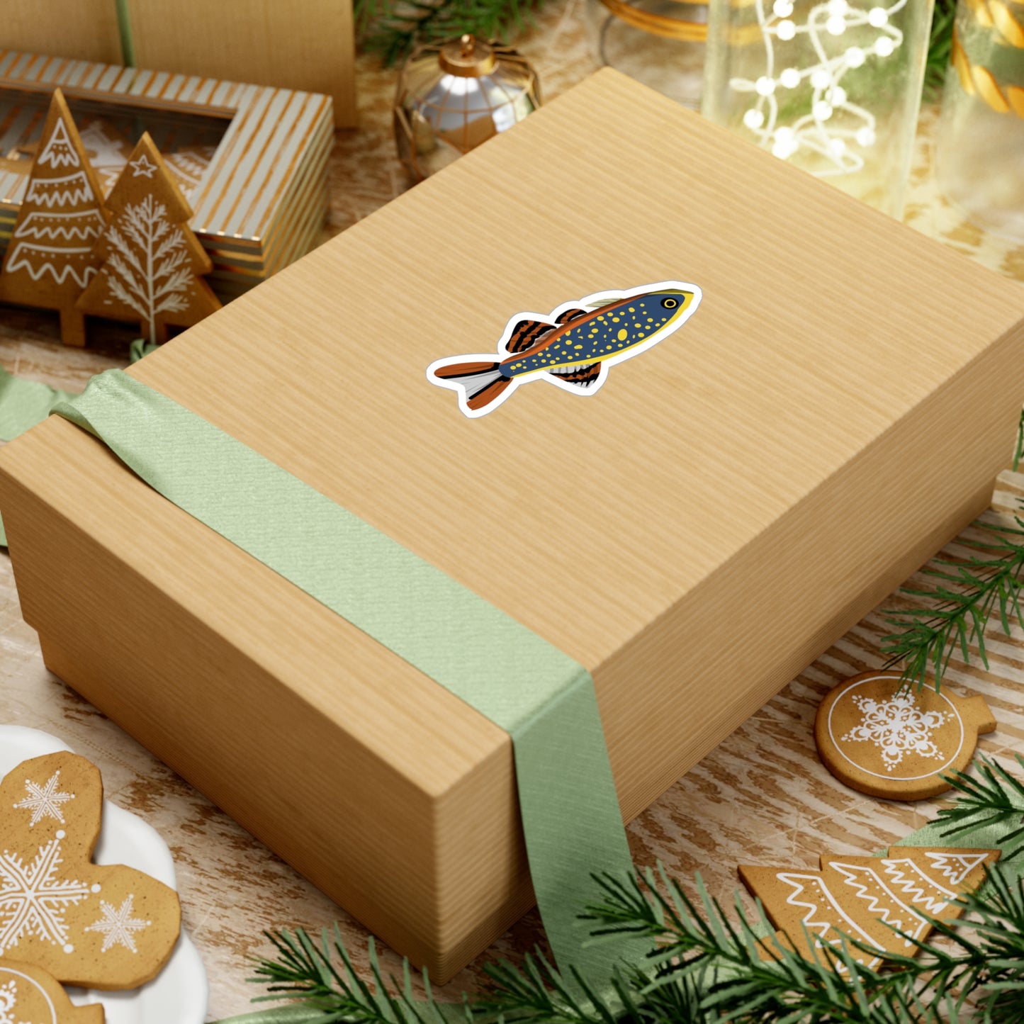Celestial Pearl Danio sticker on a brown gift box with green ribbon surrounded by holiday decorations