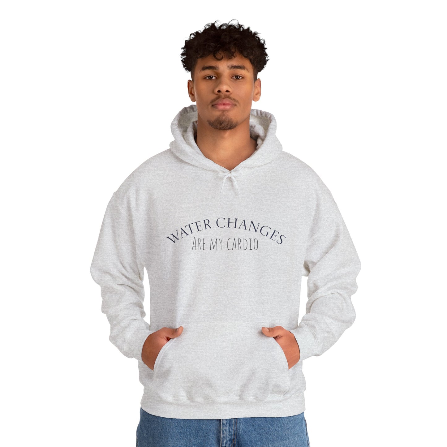 White funny fishkeeping hoodie with Water Changes Are My Cardio text worn by man with hands in pockets