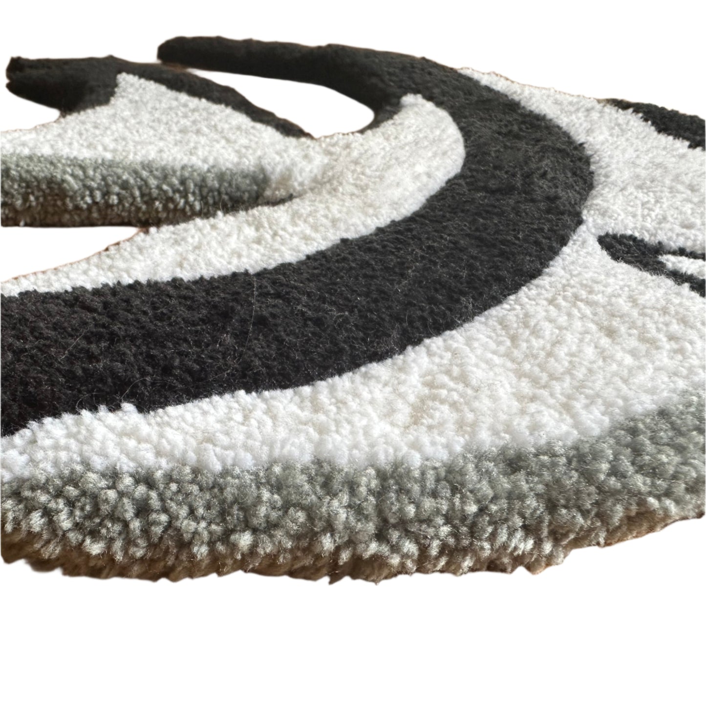 Close-up of Scallywag's Fish Bowl handmade angelfish rug showing black white and gray textured wool loops