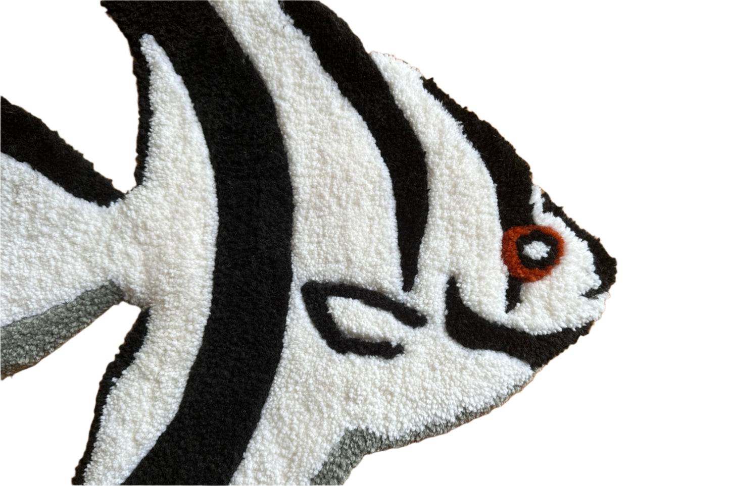 Close-up of handmade angelfish rug by Scallywags Fish Bowl featuring black and white stripes with orange eye detail