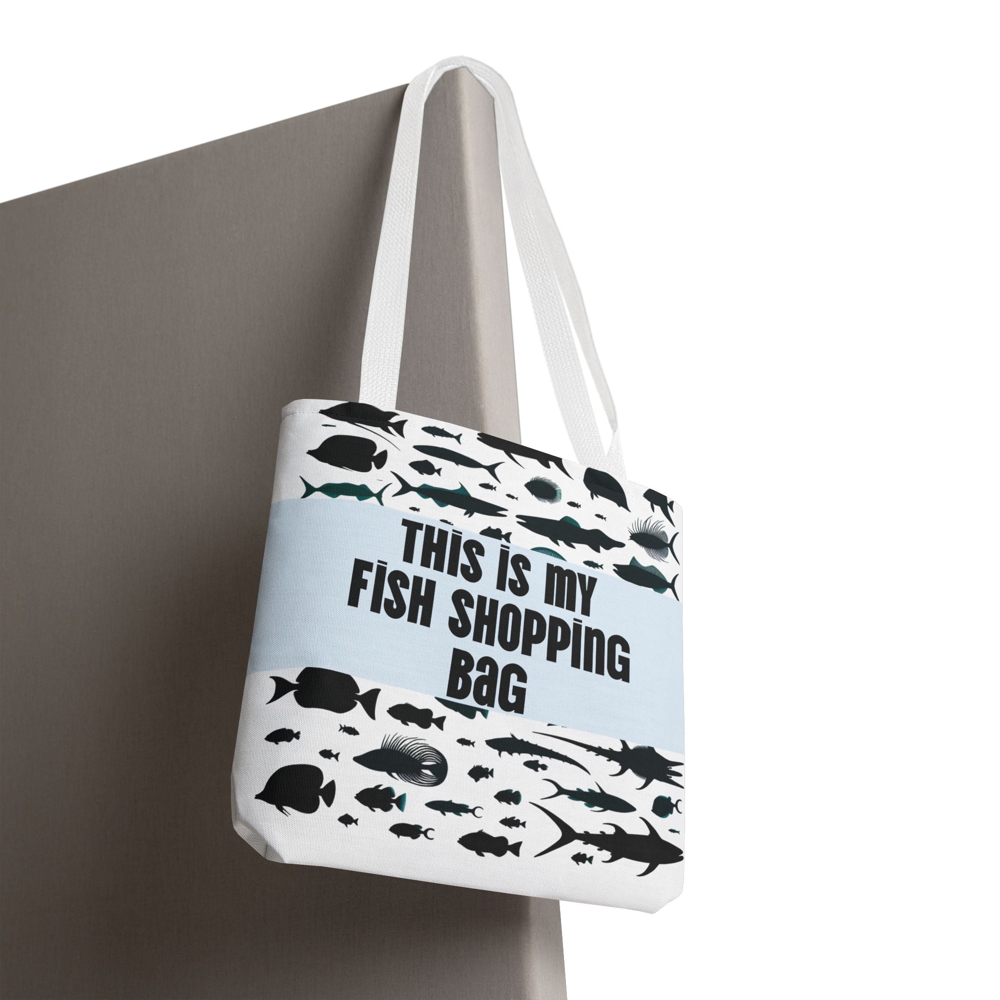 Tote bag with fish designs and text on a white background