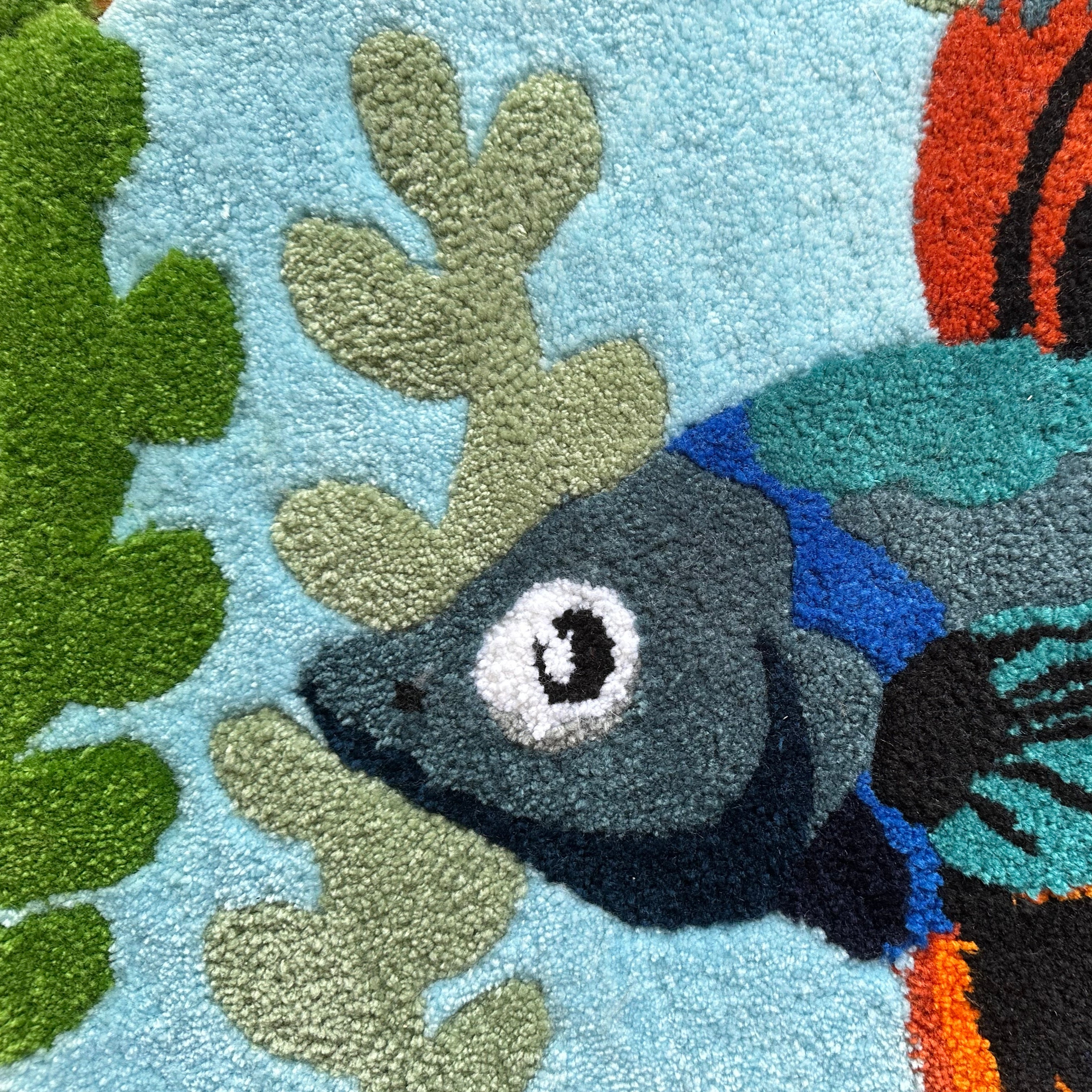 Close-up of Scallywag's Fish Bowl colorful fish rug with detailed blue and green aquatic design