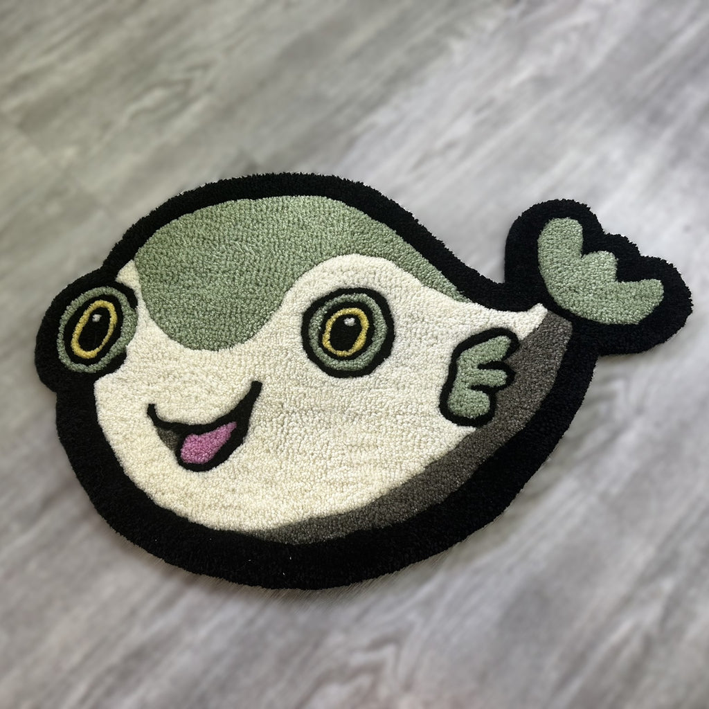 Cute Fish Rug by Scallywags Fish Bowl featuring a smiling green and white fish design on gray floor