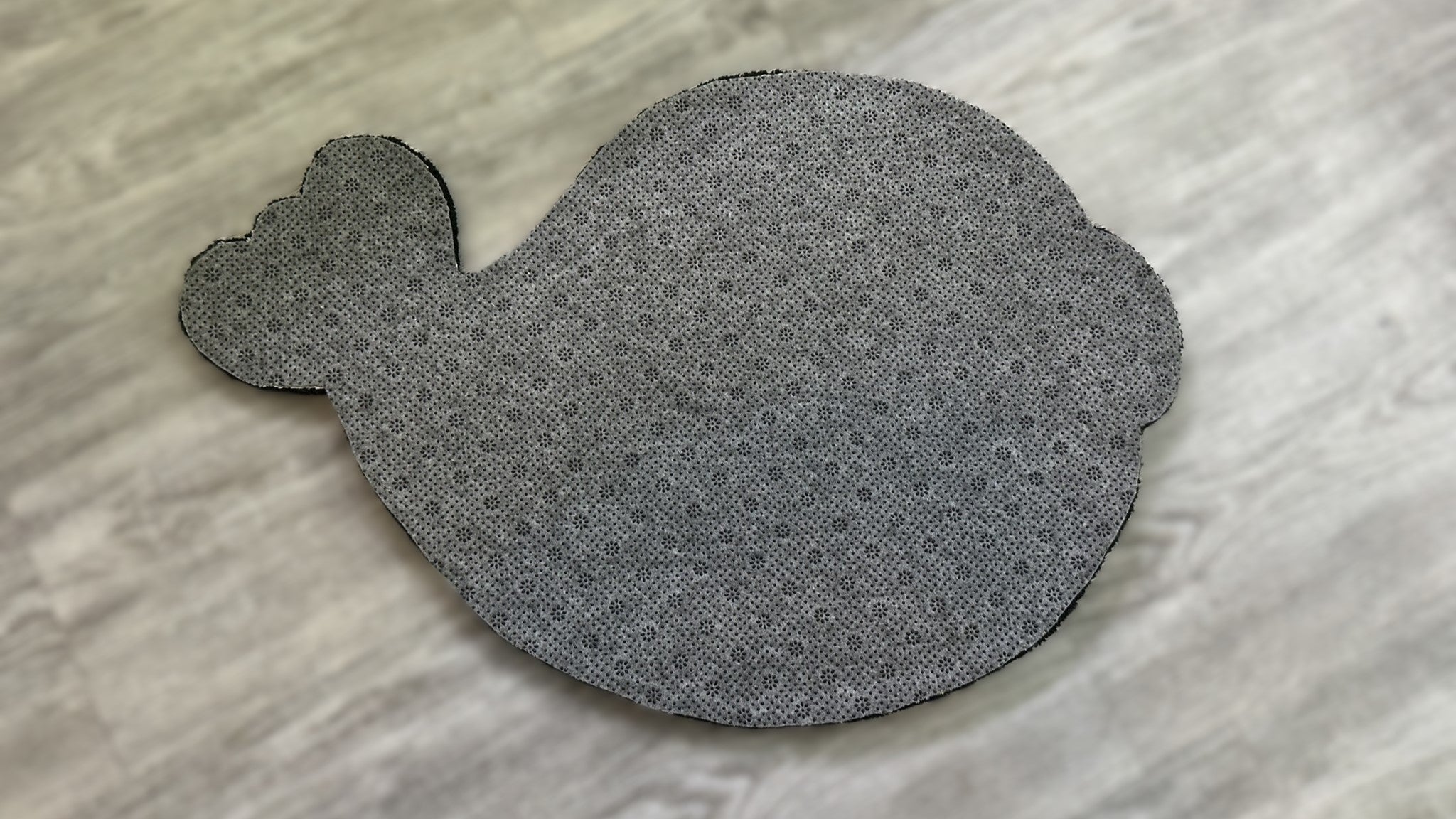 Scallywag's Fish Bowl cute fish rug with textured gray pattern and scalloped edges on wooden floor
