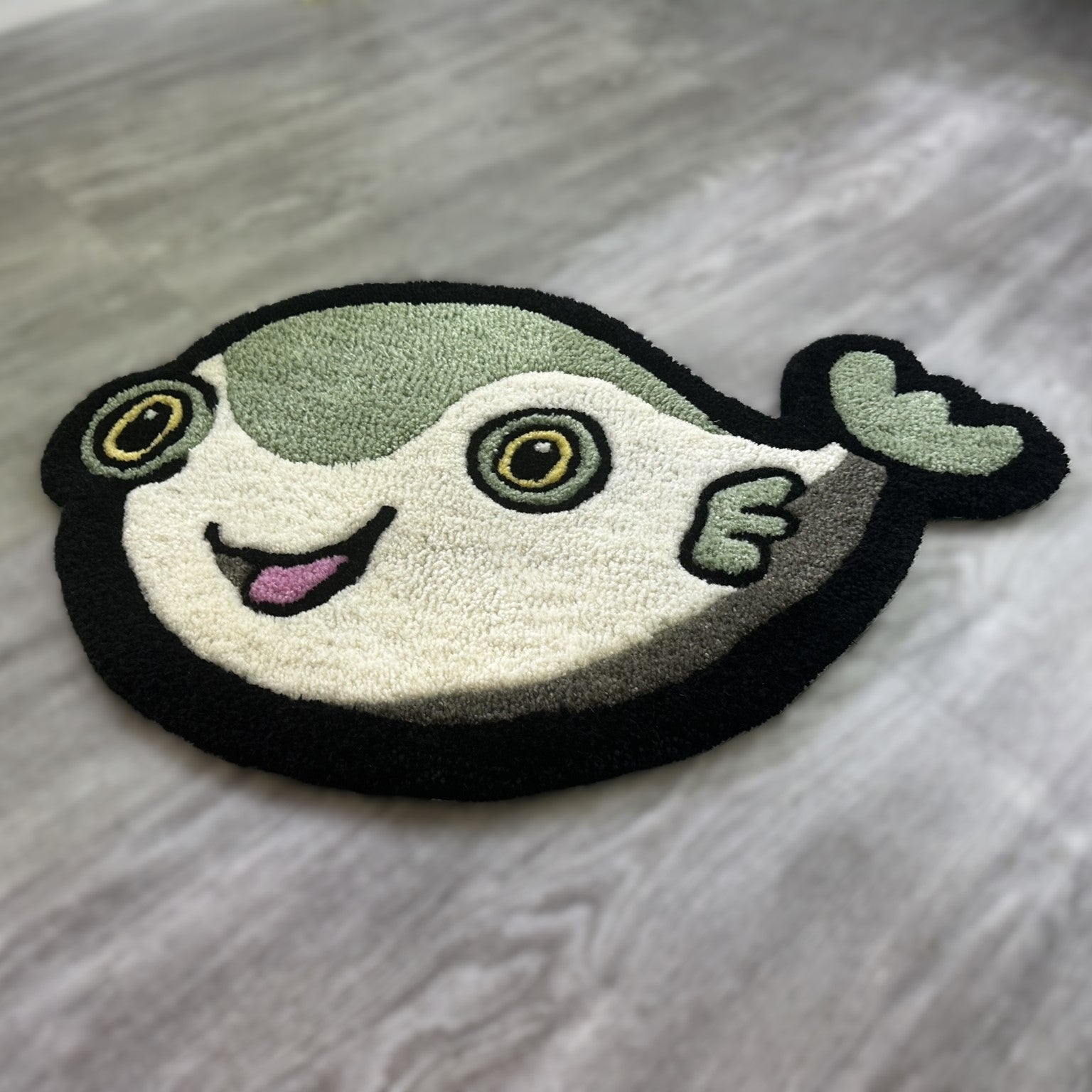 Scallywags Fish Bowl cute fish rug in playful pufferfish design with green, black, and white colors
