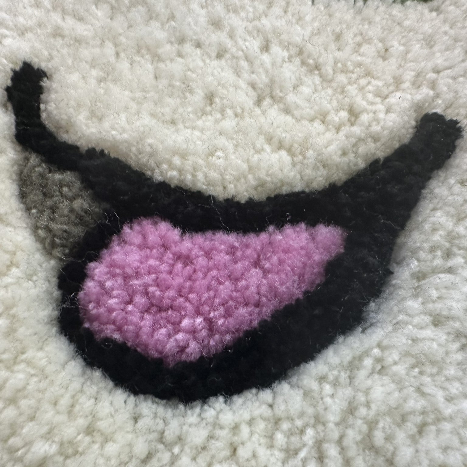 Close-up of Scallywags Fish Bowls cute fish rug showing soft textured fibers in pink black and white colors