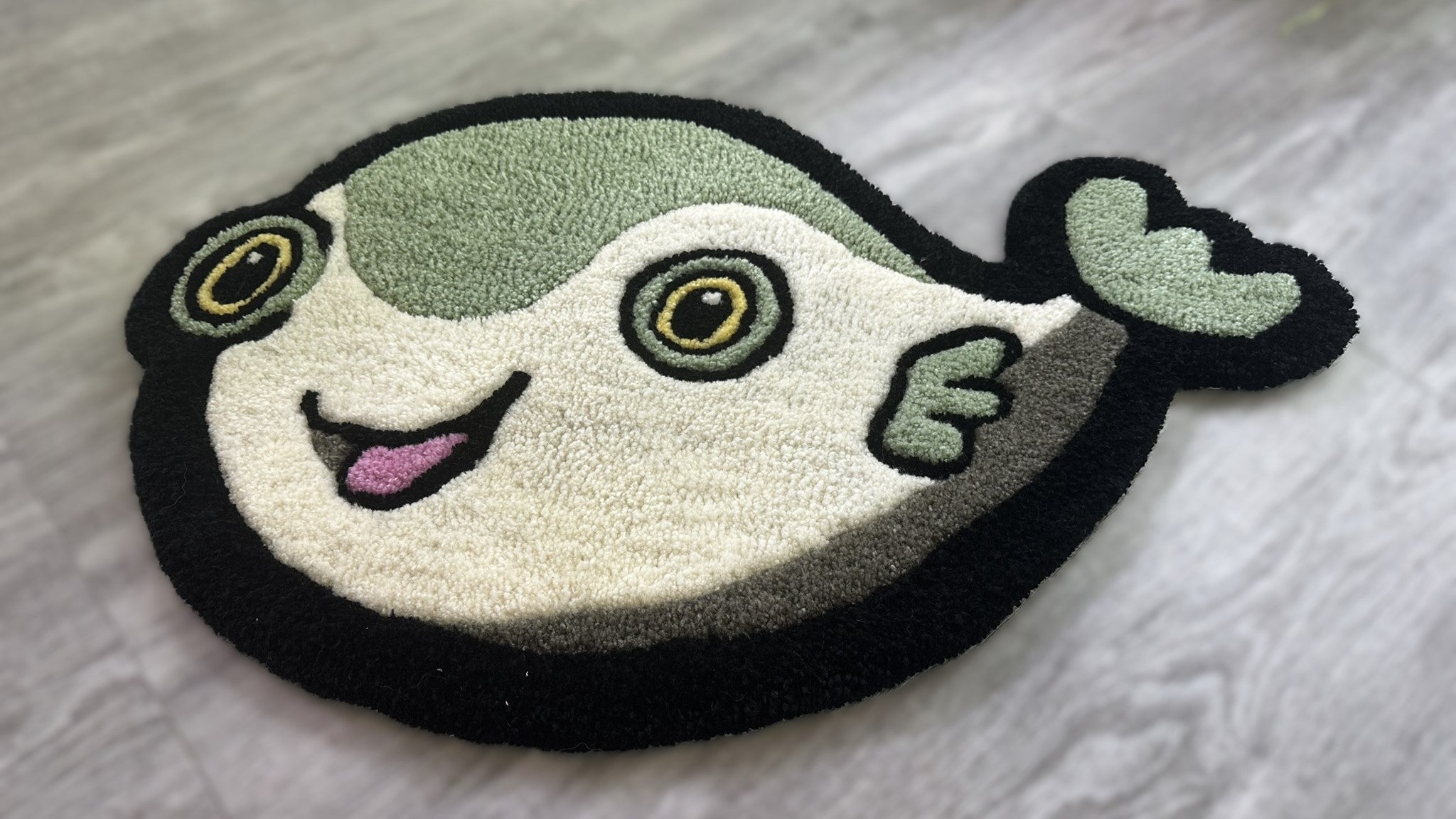 Scallywags Fish Bowl Cute Fish Rug with smiling pufferfish design in green and black colors