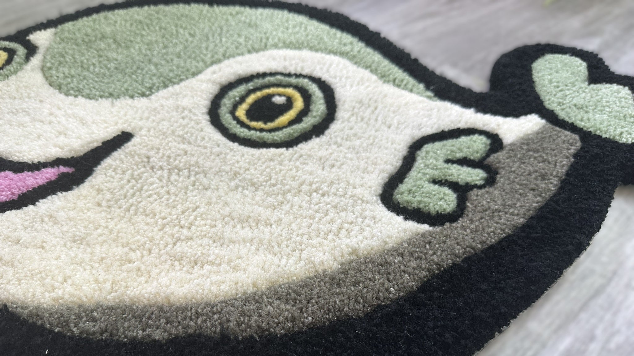 Scallywags Fish Bowl cute fish rug with green, white, and black colors on wooden floor