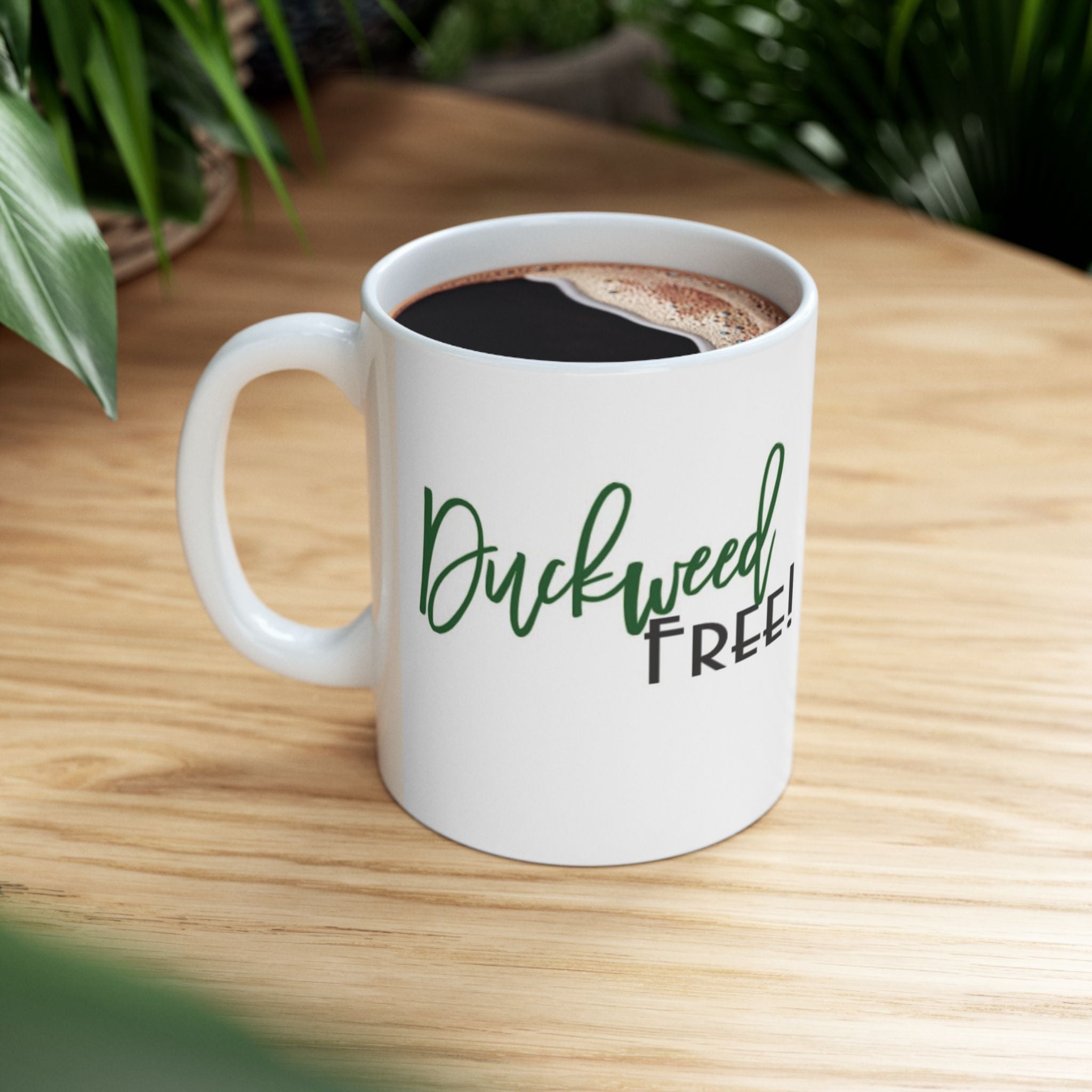White mug with green and black text reading duckweed free ideal duckweed free aquarium gift