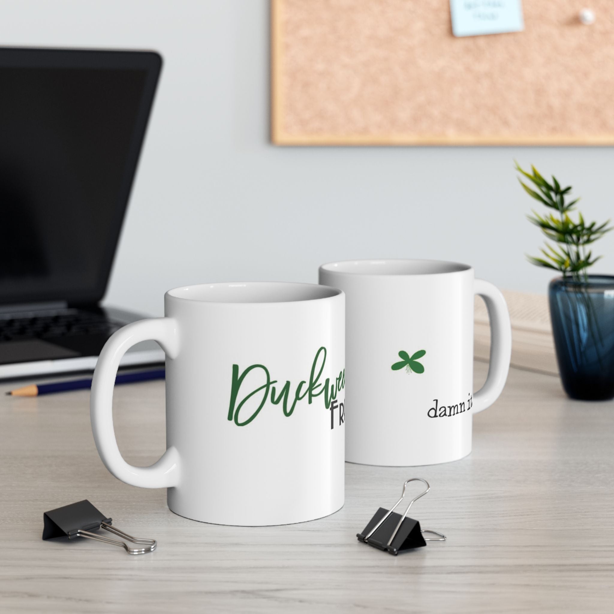 White Printify mugs with green text and design perfect as a duckweed free aquarium gift on a desk