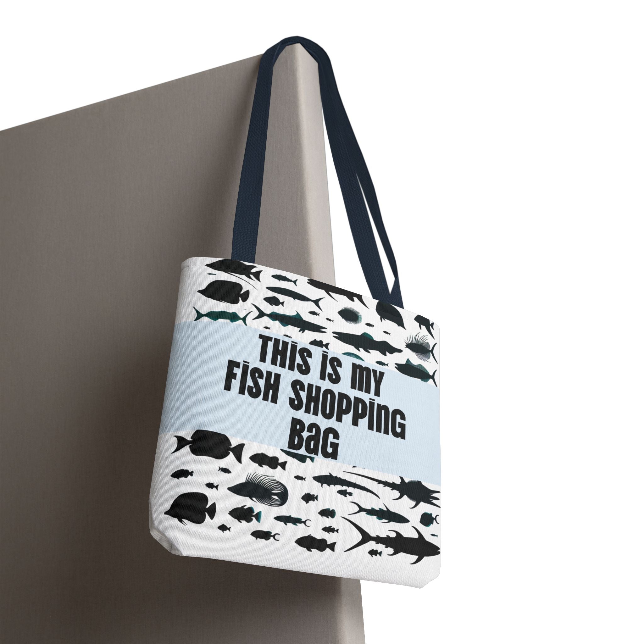Tote bag with fish illustrations and text 'This is my fish shopping bag' on a light blue background.