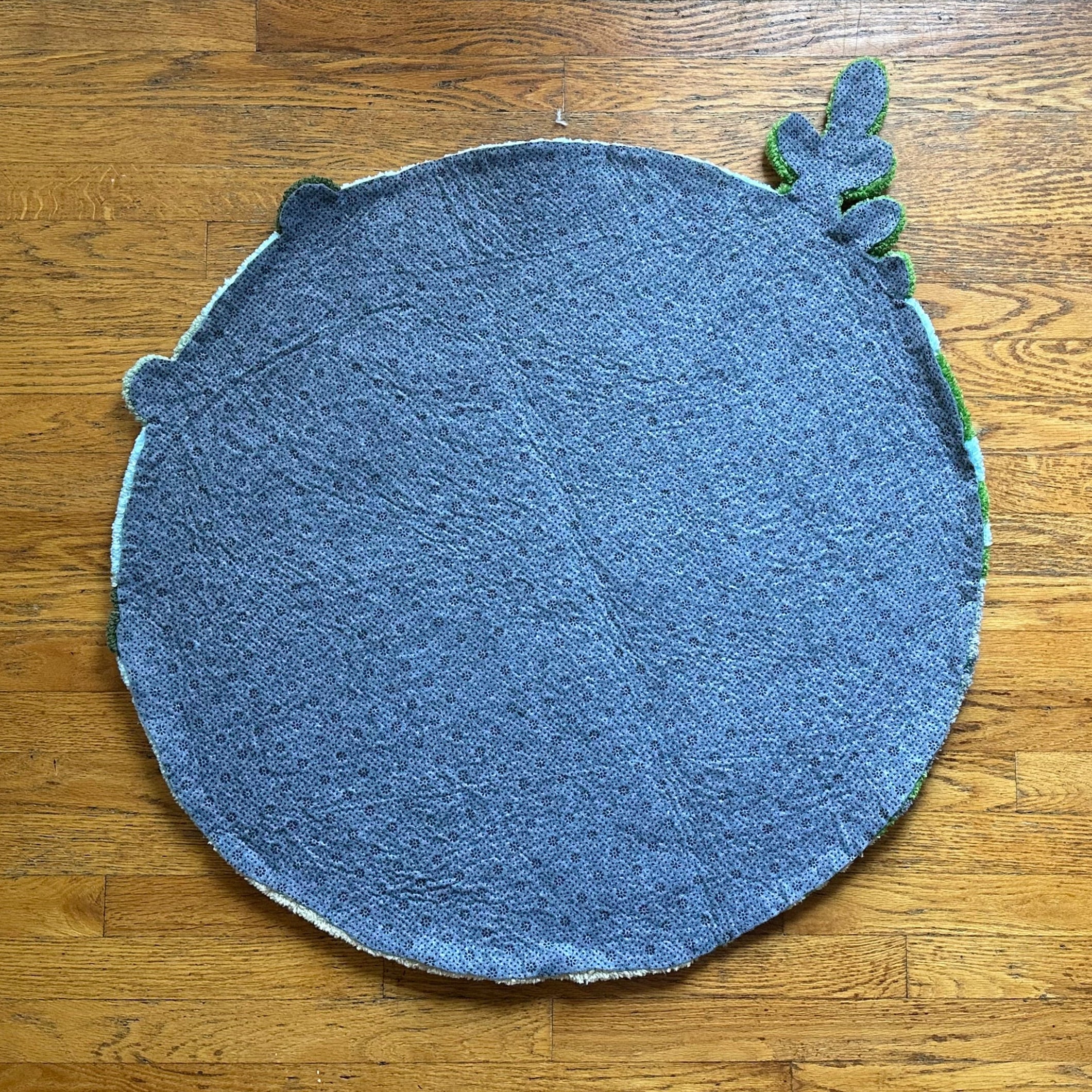 Back view of Scallywag's Fish Bowl handmade betta fish rug showing fabric texture and backing