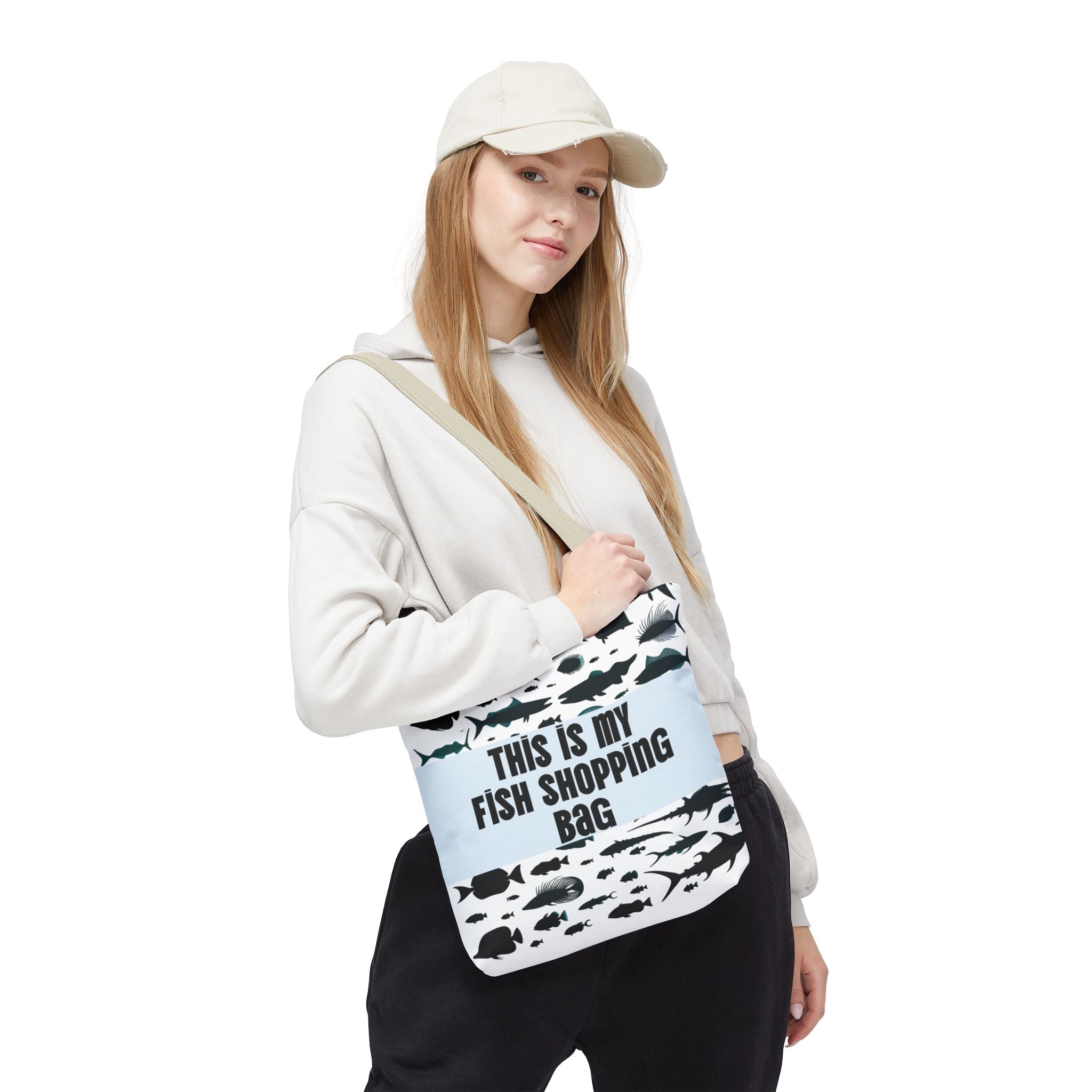Person holding a novelty shopping bag with fish design and text on a white background