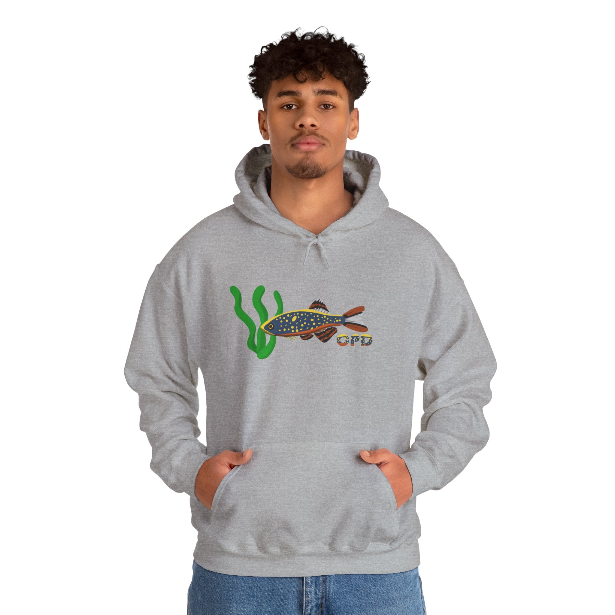Man wearing grey hoodie with Galaxy Rasbora fish swimming toward plants, hands in pocket
