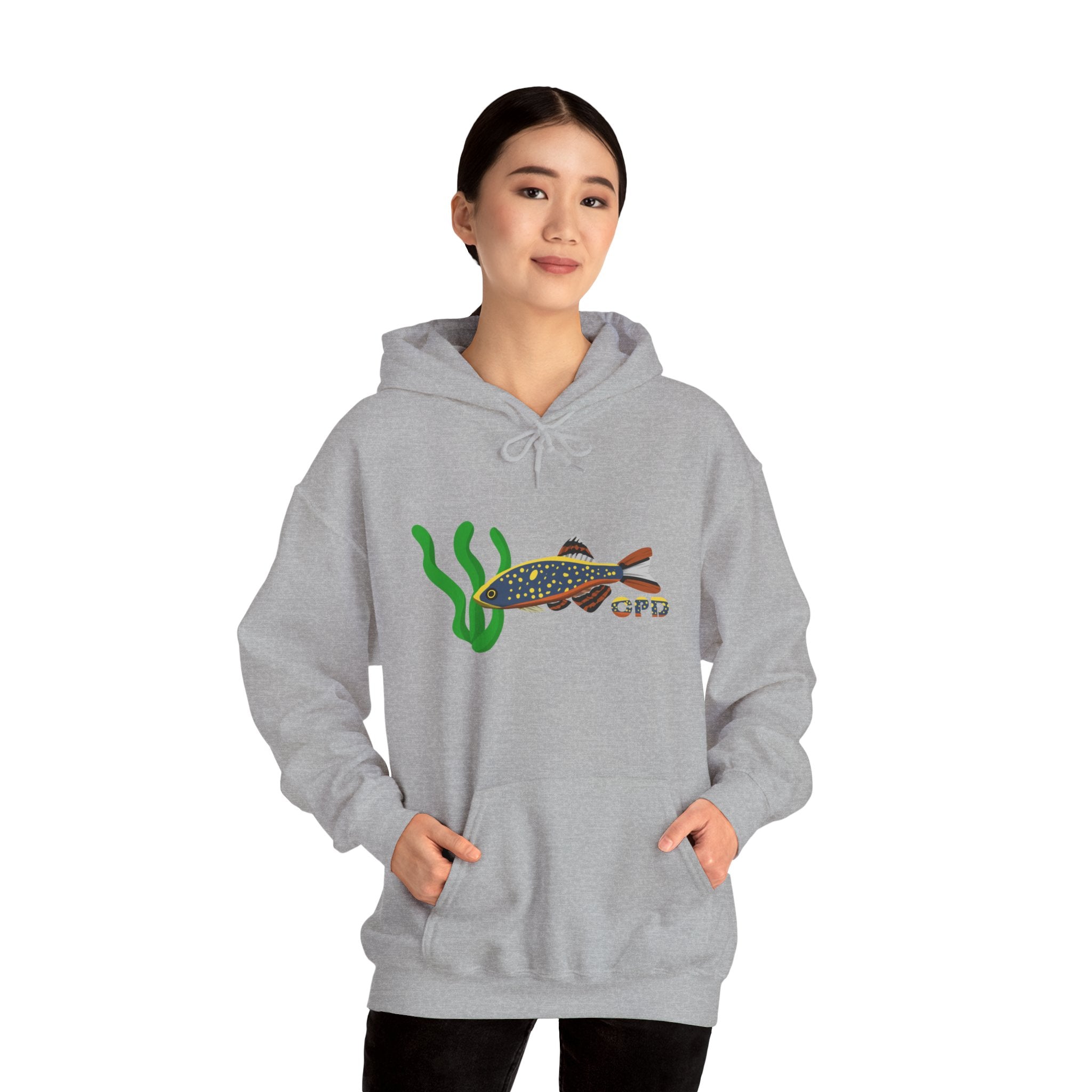 Woman in oversized grey hoodie with Galaxy Rasbora chest design, hands in front pocket
