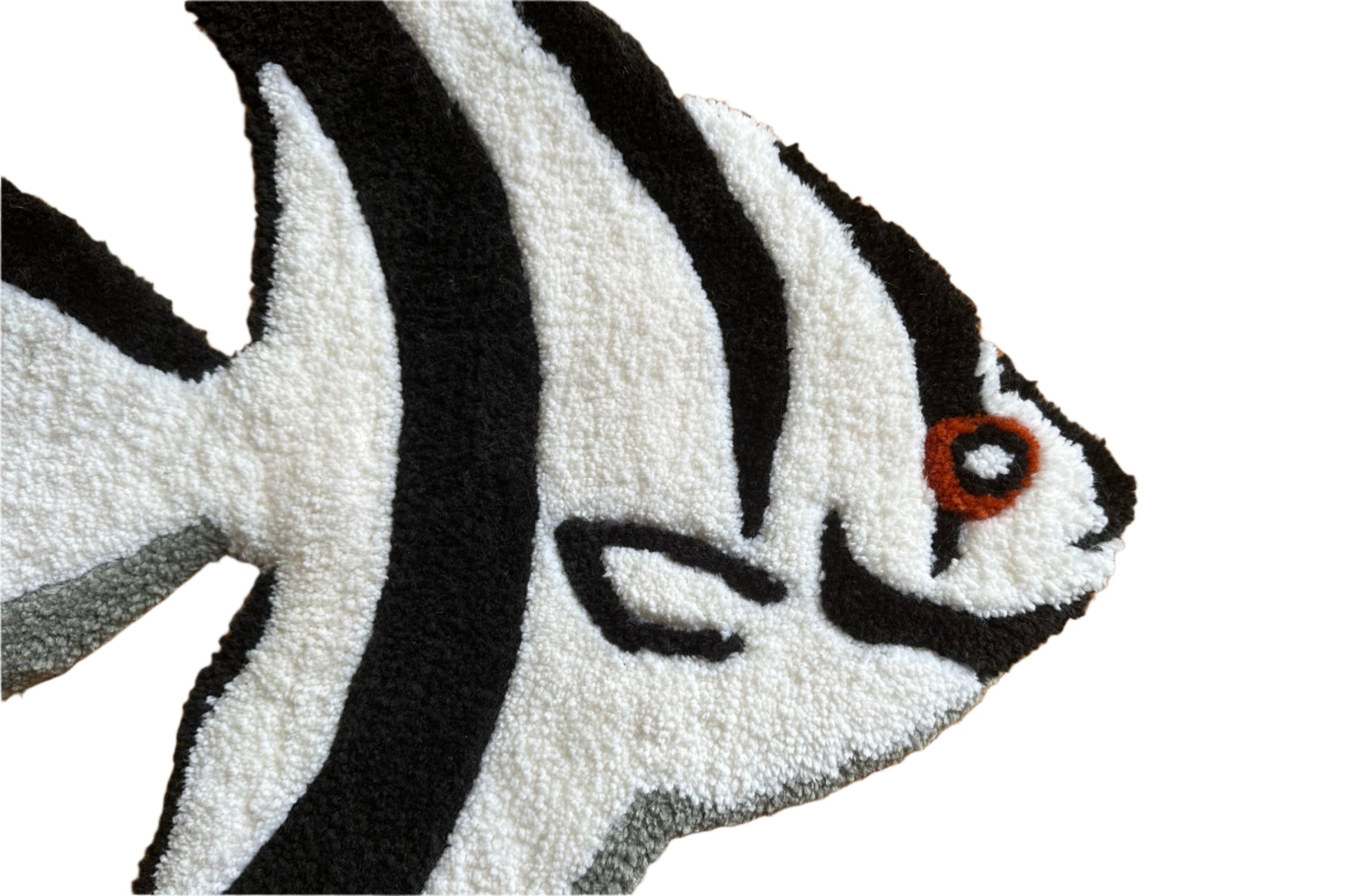 Close-up of handmade angelfish rug by Scallywags Fish Bowl featuring black and white stripes with orange eye detail