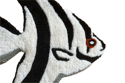 Close-up of handmade angelfish rug by Scallywags Fish Bowl featuring black and white stripes with orange eye detail