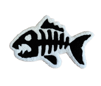 Handmade fish bones rug by Scallywag's Fish Bowl shaped like a white fish skeleton on black background