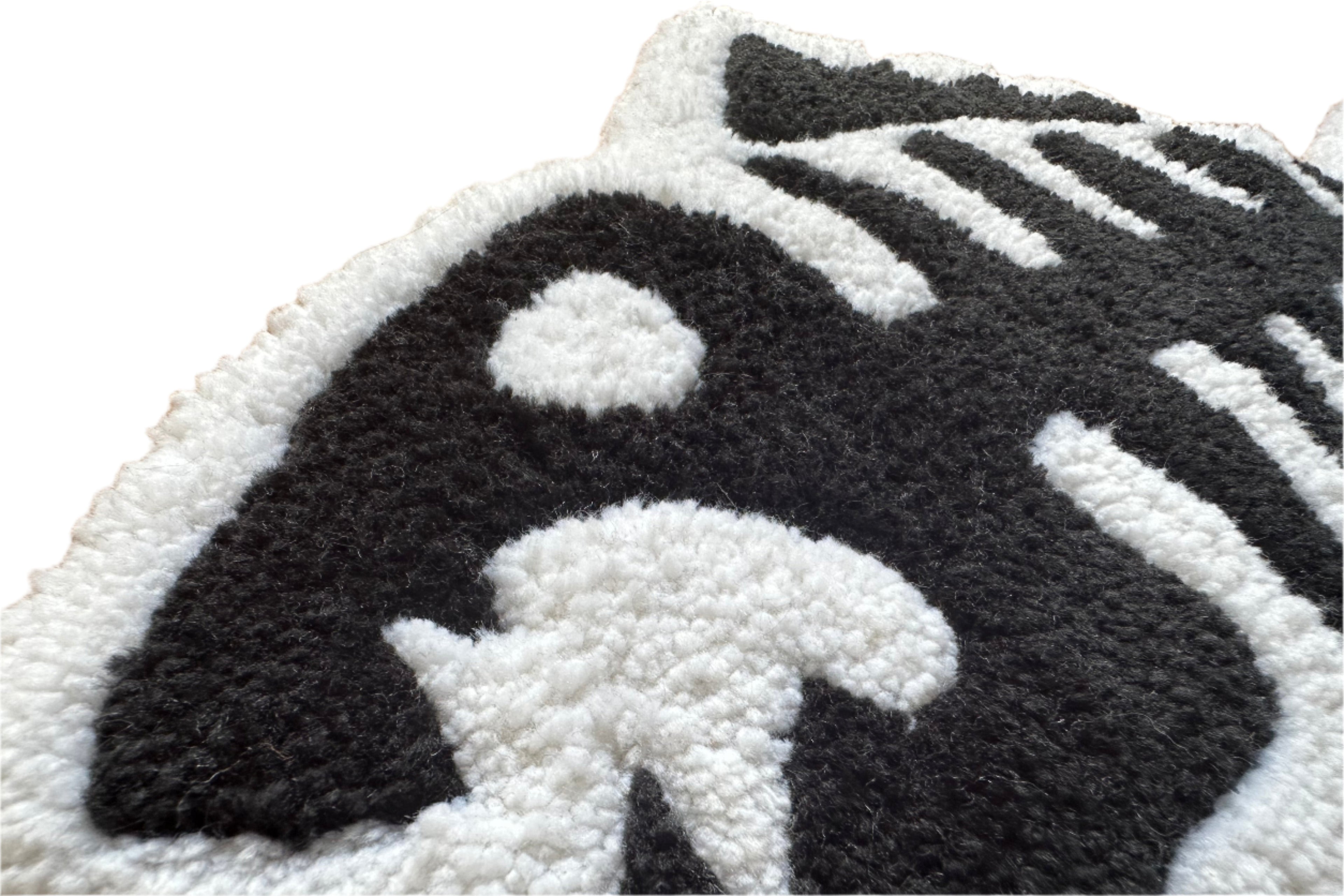 Close-up of Scallywag's Fish Bowl handmade fish bones rug with textured black and white design