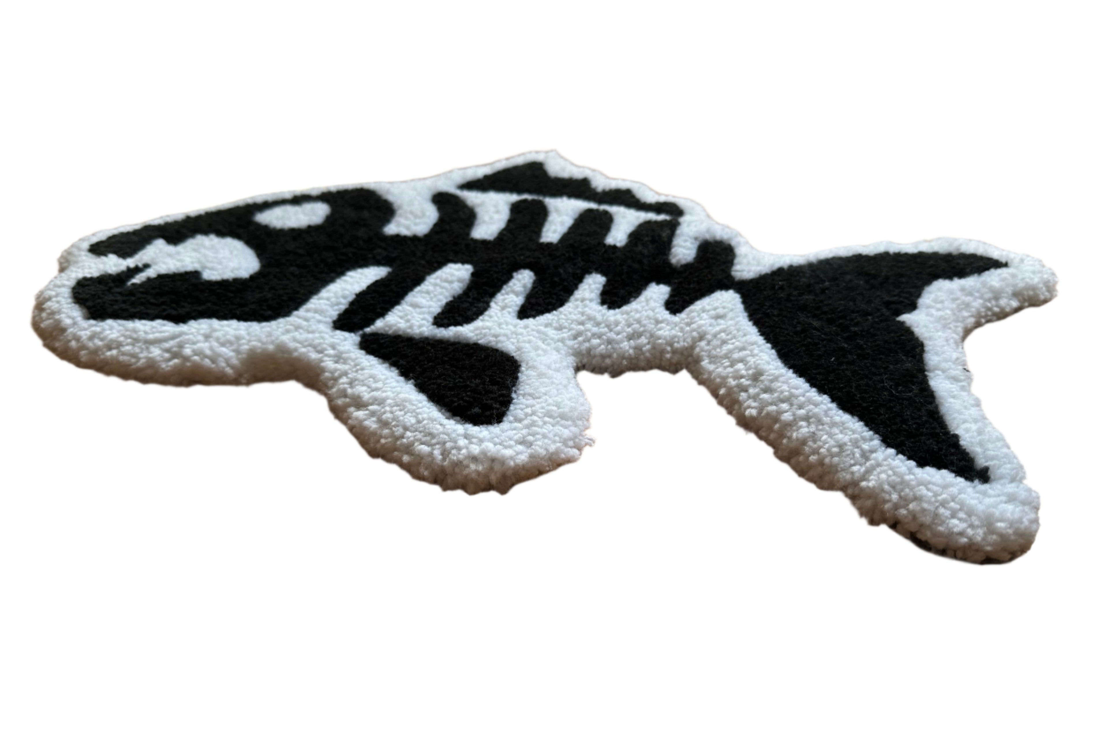 Scallywags Fish Bowls handmade fish bones rug in black and white shaped like a fish skeleton