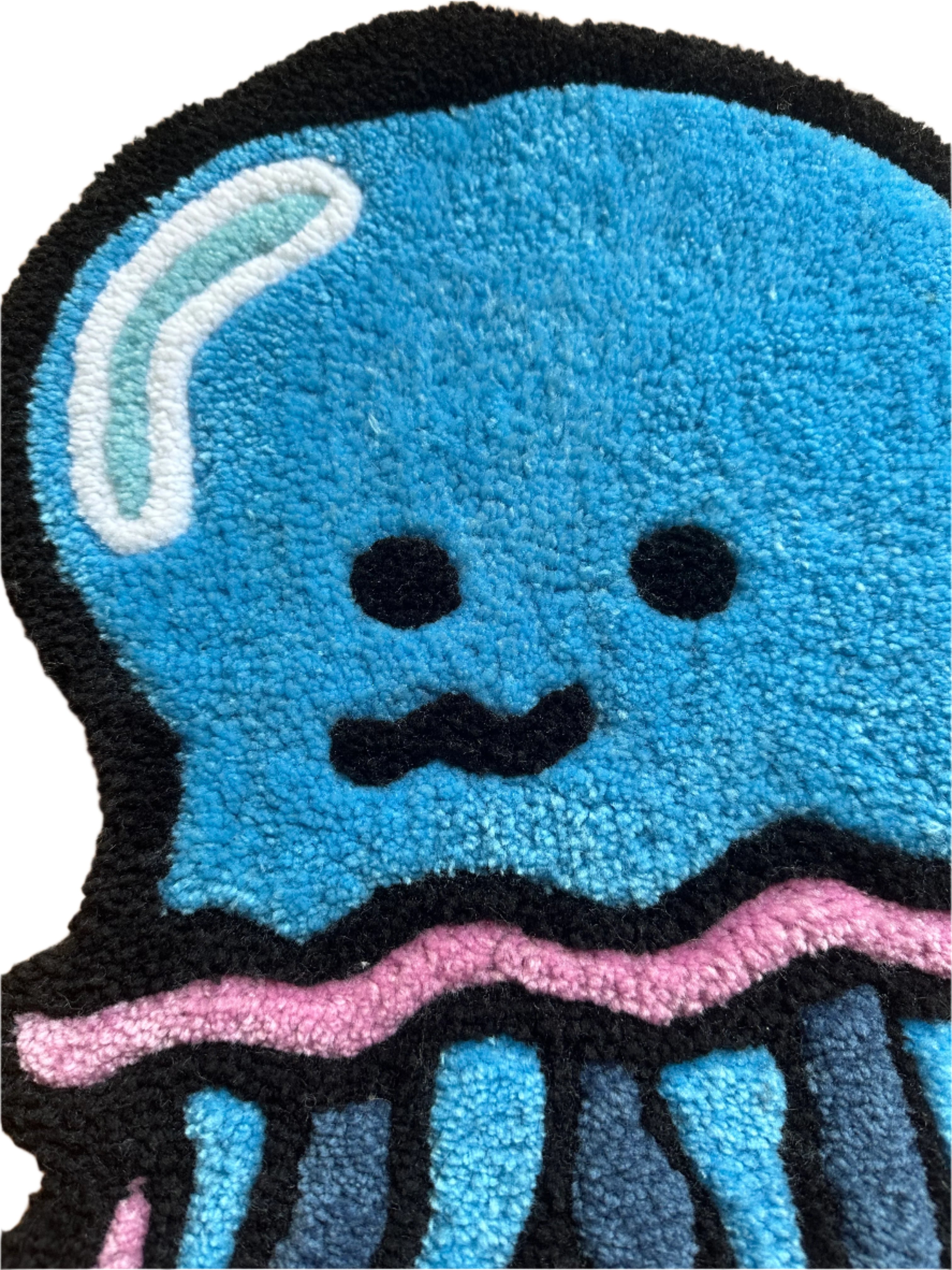 Scallywag's Fish Bowl handmade jellyfish rug in blue with black and pink accents and a cute face design