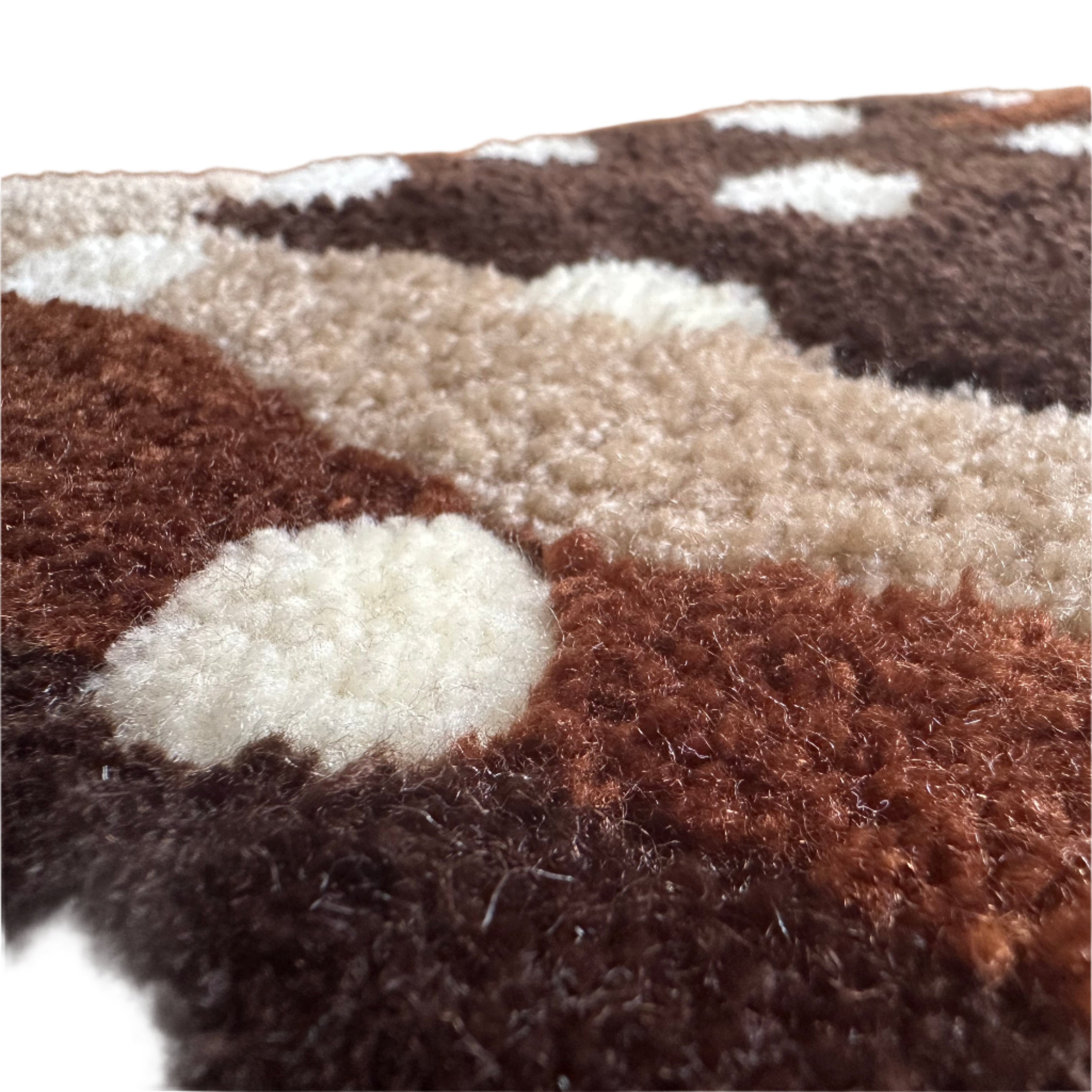 Close-up of handmade pleco rug showing soft textured fibers in brown and cream colors