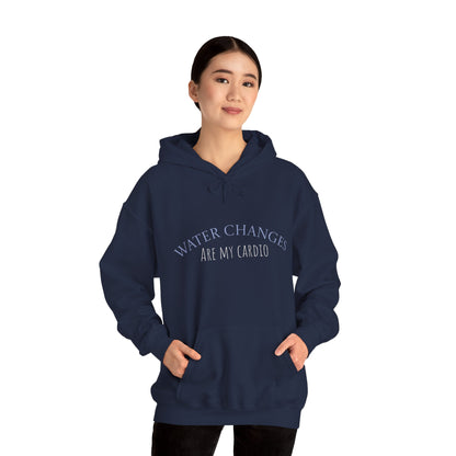 Front view of woman wearing navy “Water Changes Are My Cardio” hoodie with arms at her sides