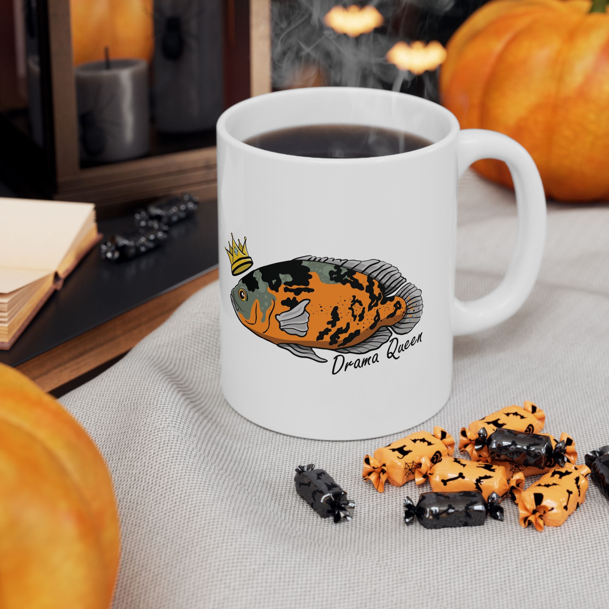 White Oscar fish mug gift with colorful fish design and crown filled with steaming coffee on a table
