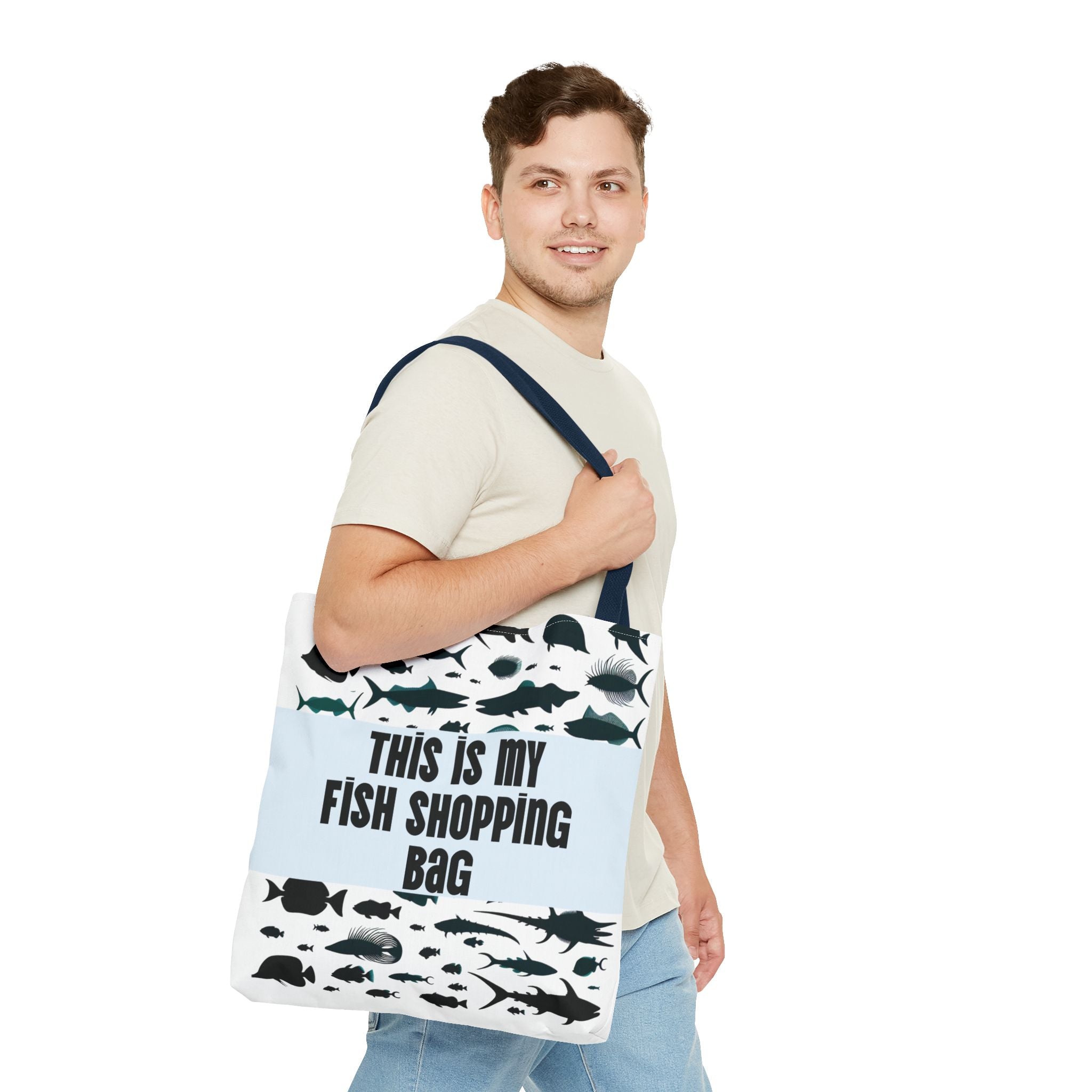 Man holding a tote bag with fish designs and text on a white background