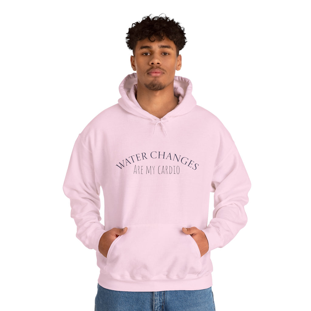 Man wearing pink “Water Changes Are My Cardio” hoodie with hands in front pocket