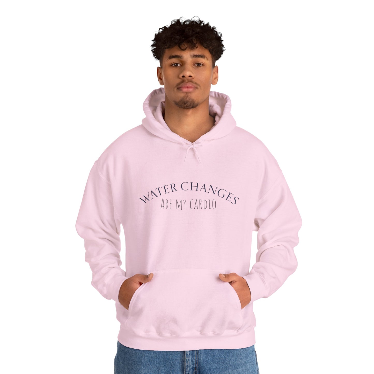 Man wearing pink “Water Changes Are My Cardio” hoodie with hands in front pocket