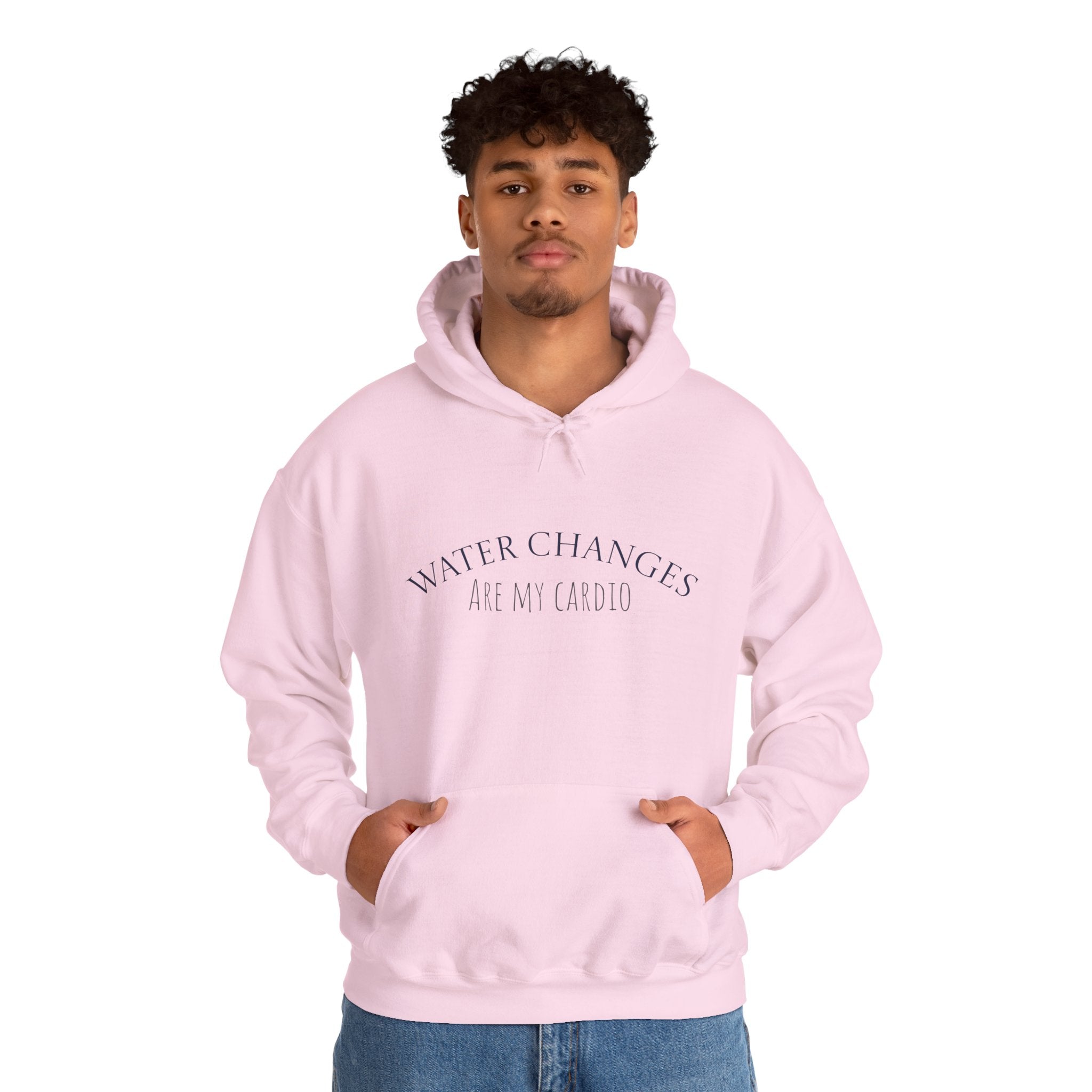 Man wearing pink “Water Changes Are My Cardio” hoodie with hands in front pocket