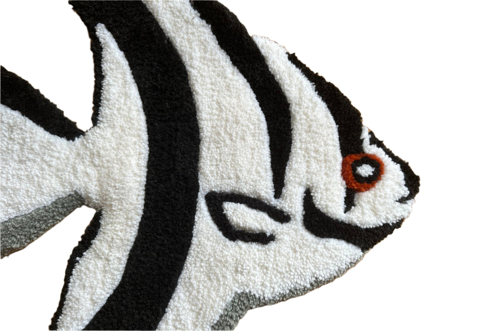 Close-up of Scallywag's Fish Bowl black and white Fish Rug with detailed orange eye design
