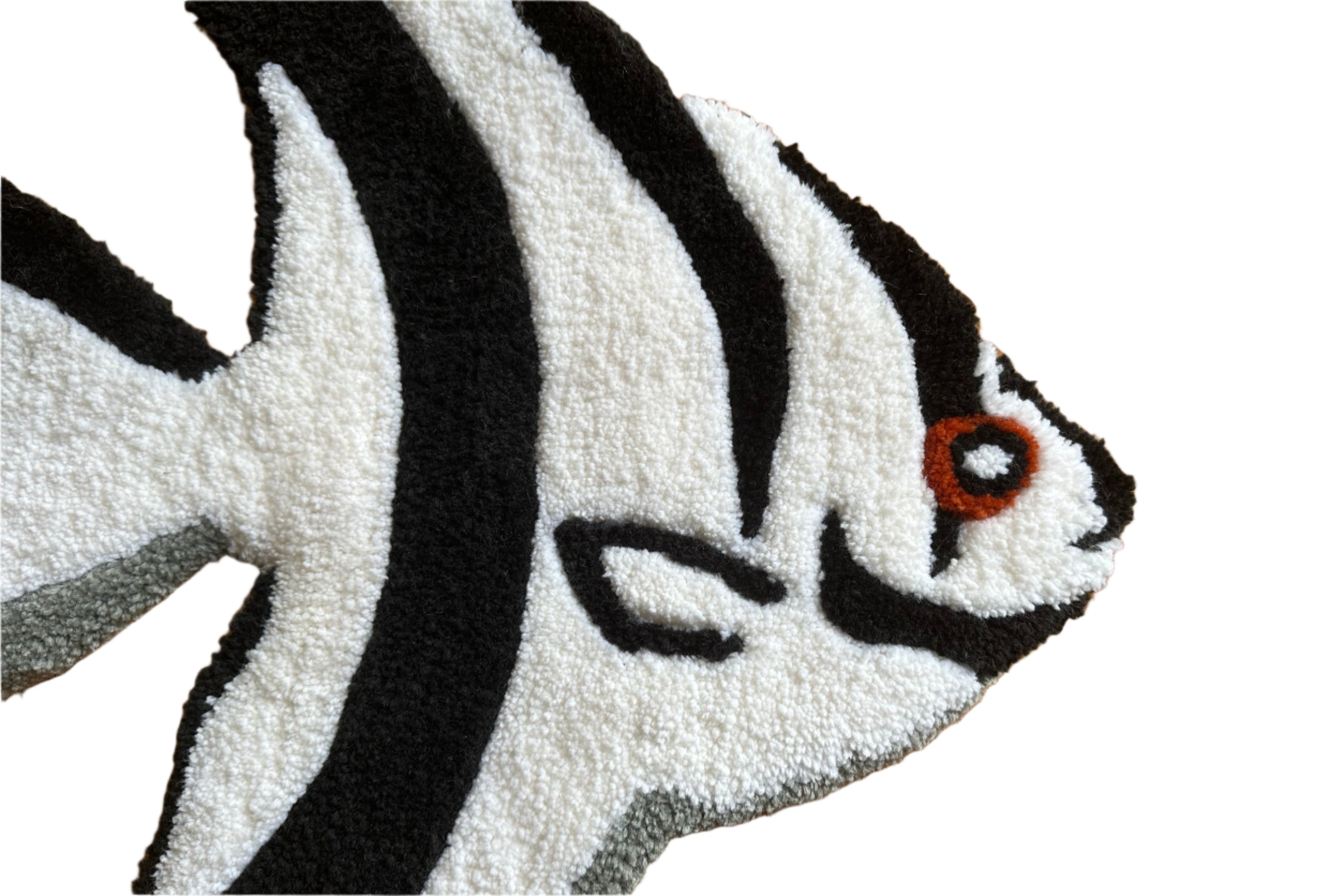 Close-up of Scallywag's Fish Bowl black and white Fish Rug with detailed orange eye design