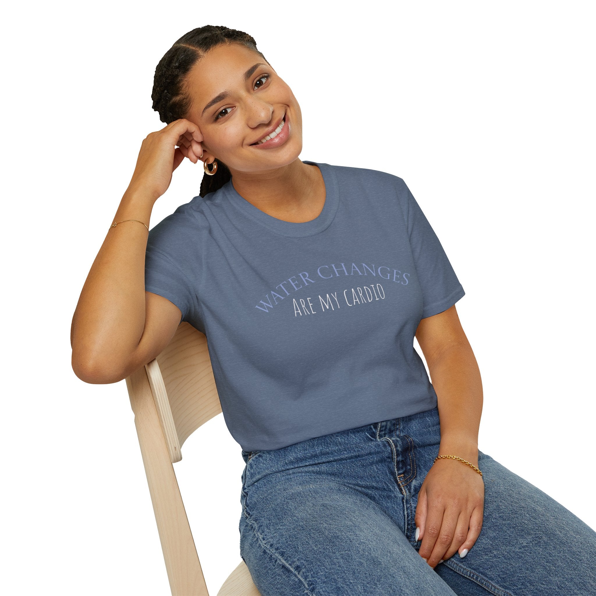 Woman wearing a blue t-shirt with text, sitting on a chair against a white background